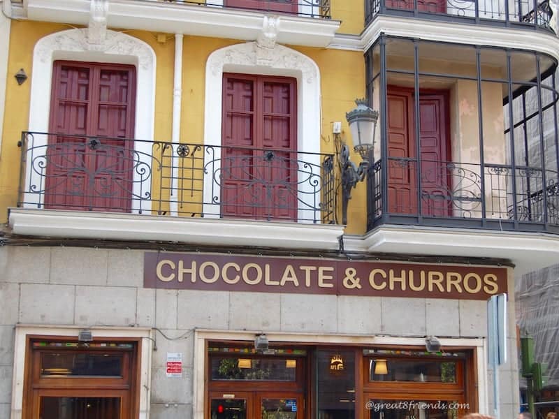 A store front with a sign that says Chocolate & Churros.