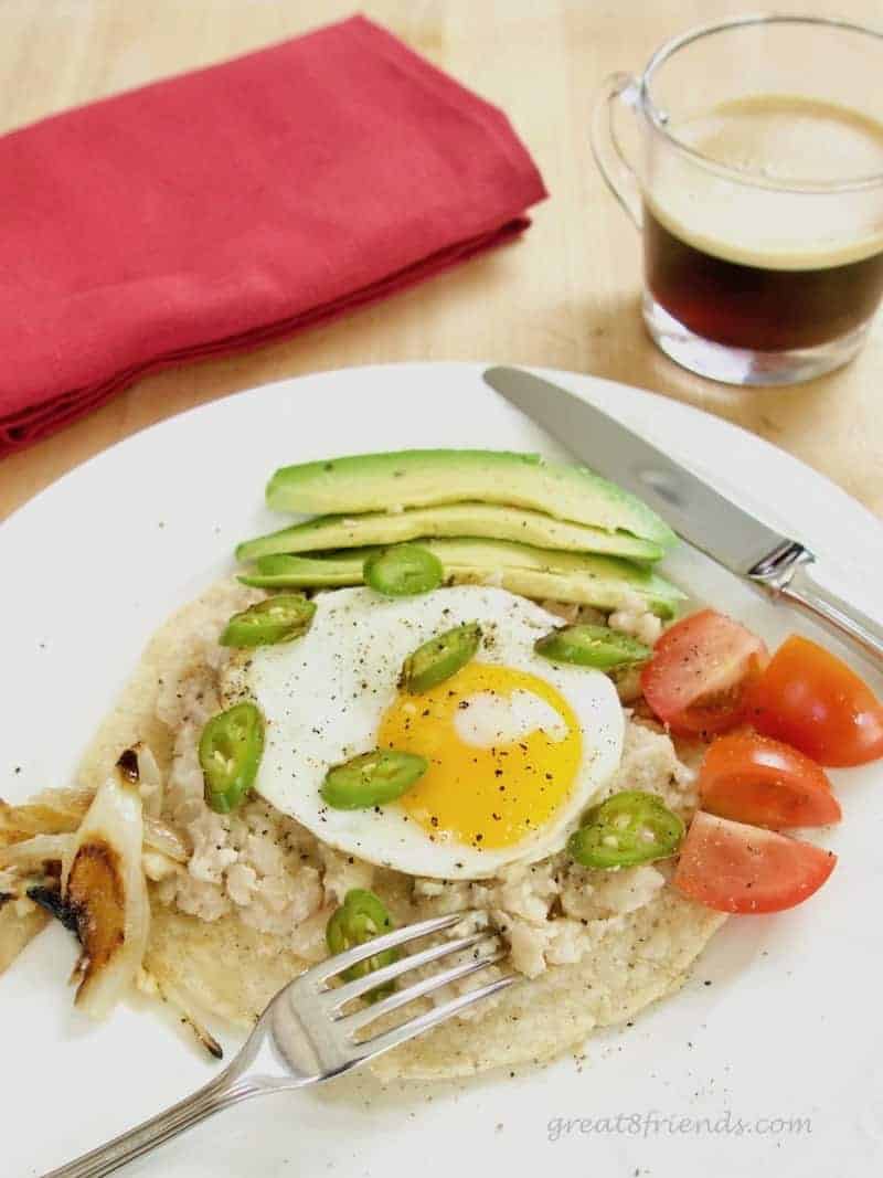 Refried beans on a tortilla with a fried egg on top.