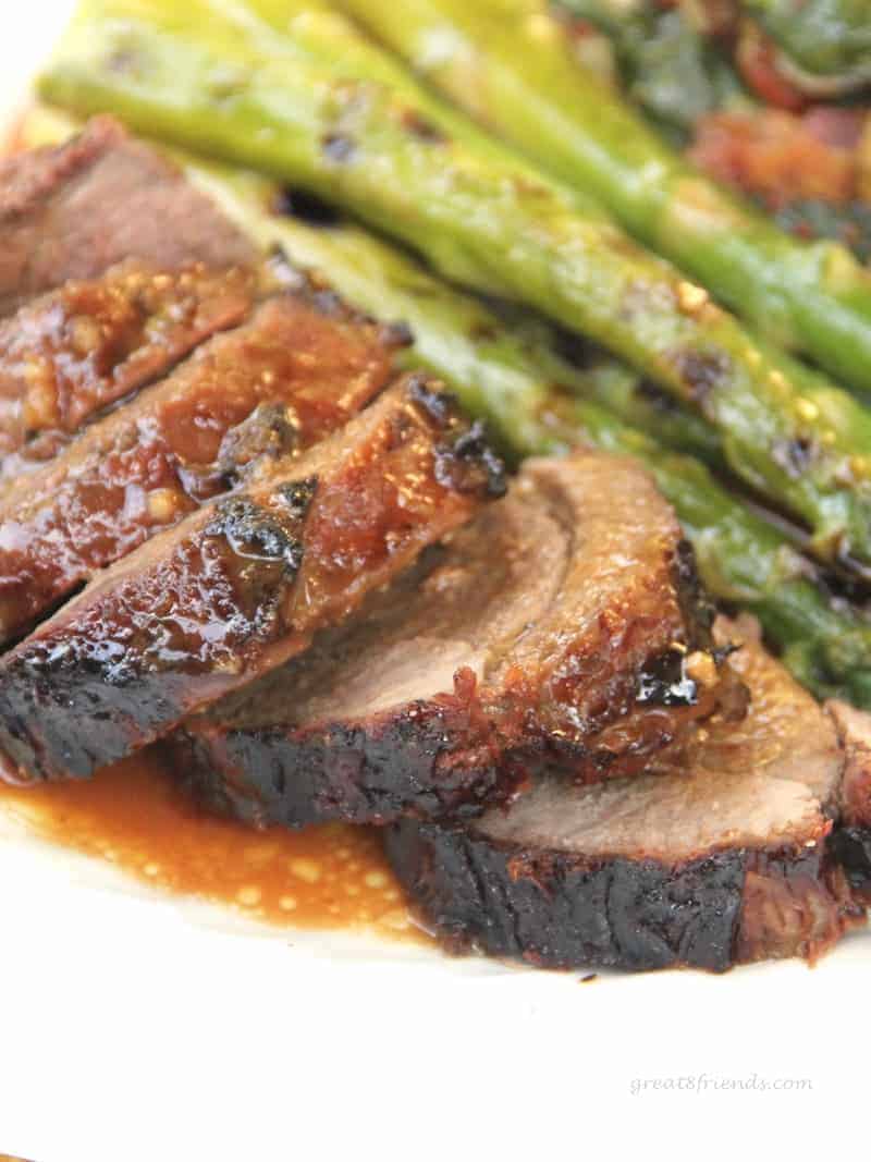 Butterflied, marinated, grilled and sliced leg of lamb served with grilled asparagus. 