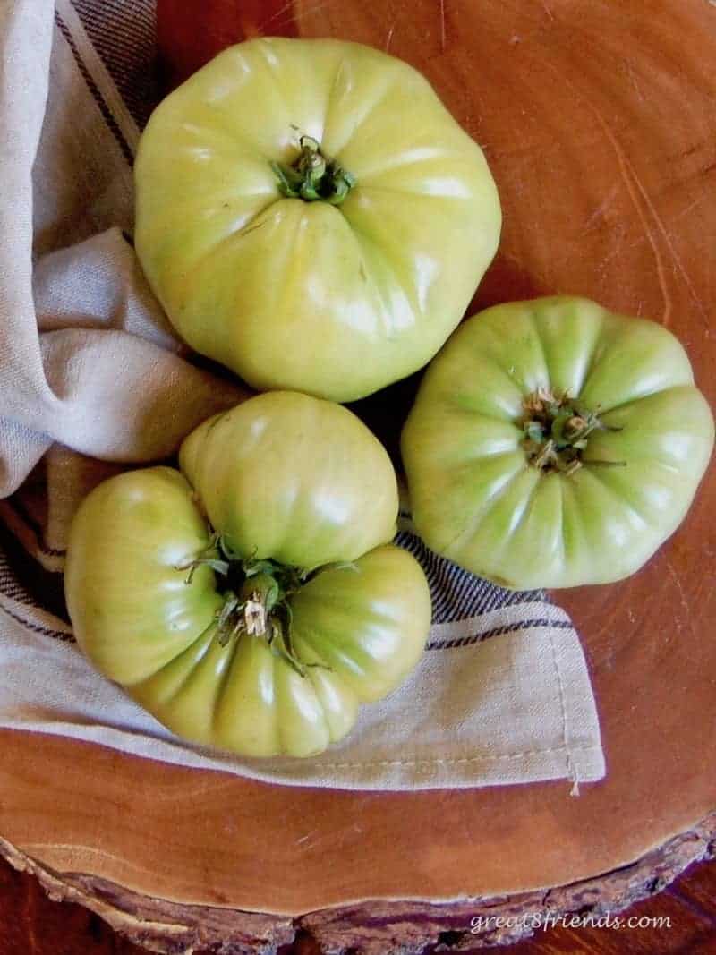 Three whole green tomatoes.