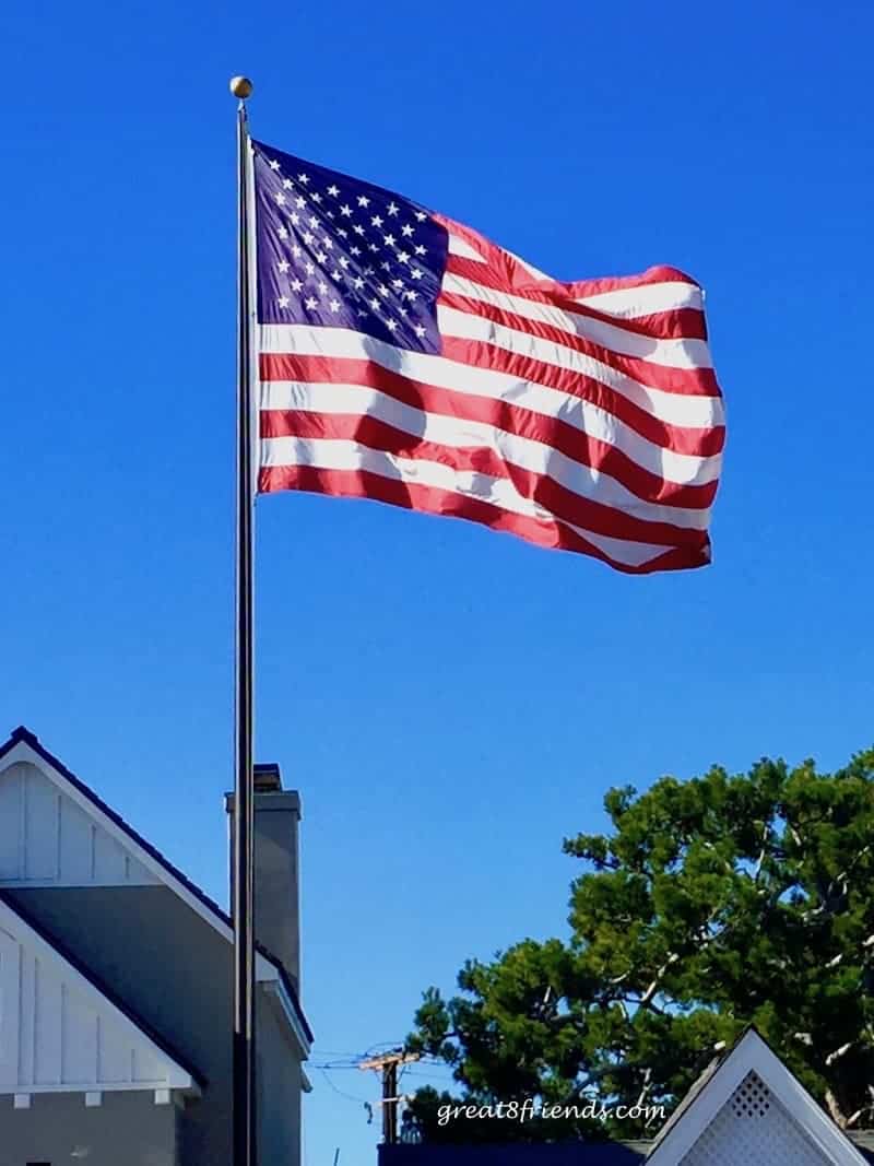 American Flag on a pole against a blue sky.