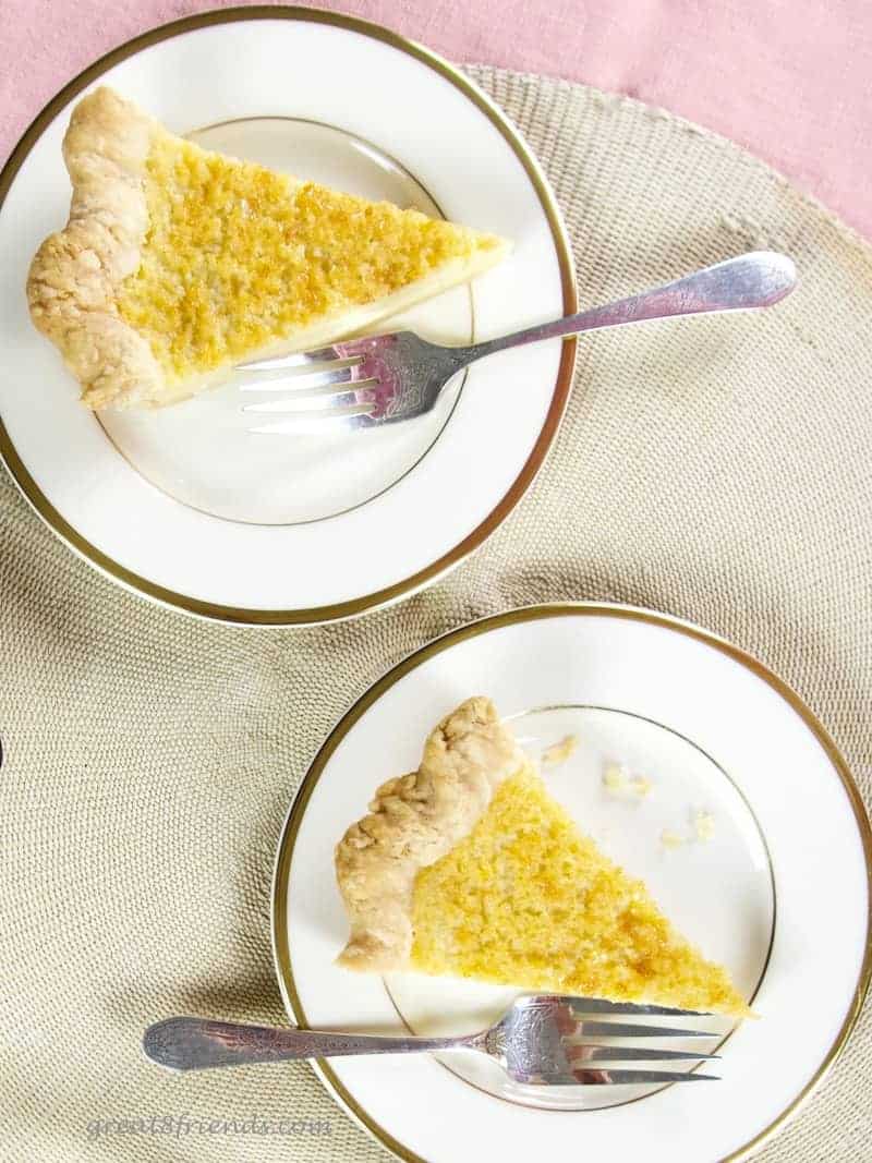 Overhead shot of two pieces of pie on plates with forks.