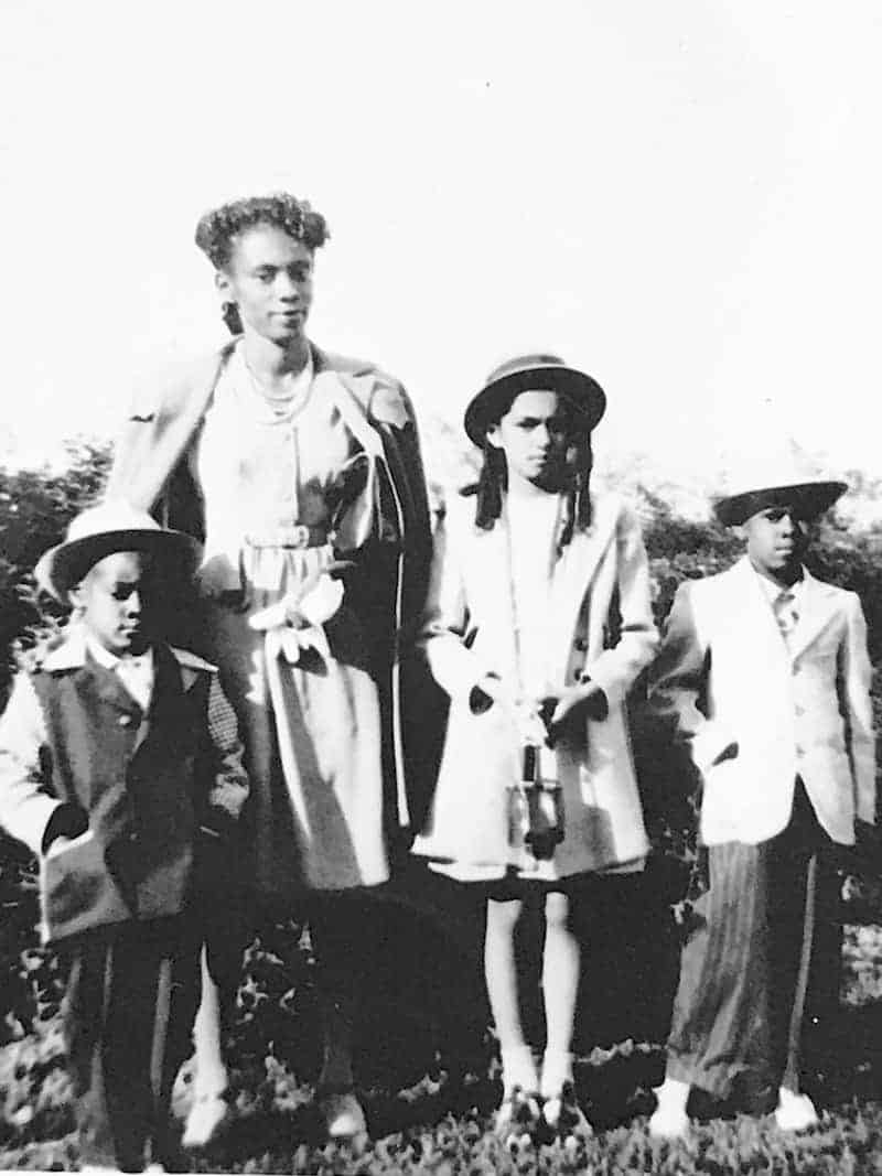 Black and white photo of an African American family of four.