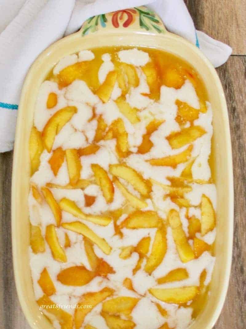Easy peach cobbler in a baking dish ready to be baked.