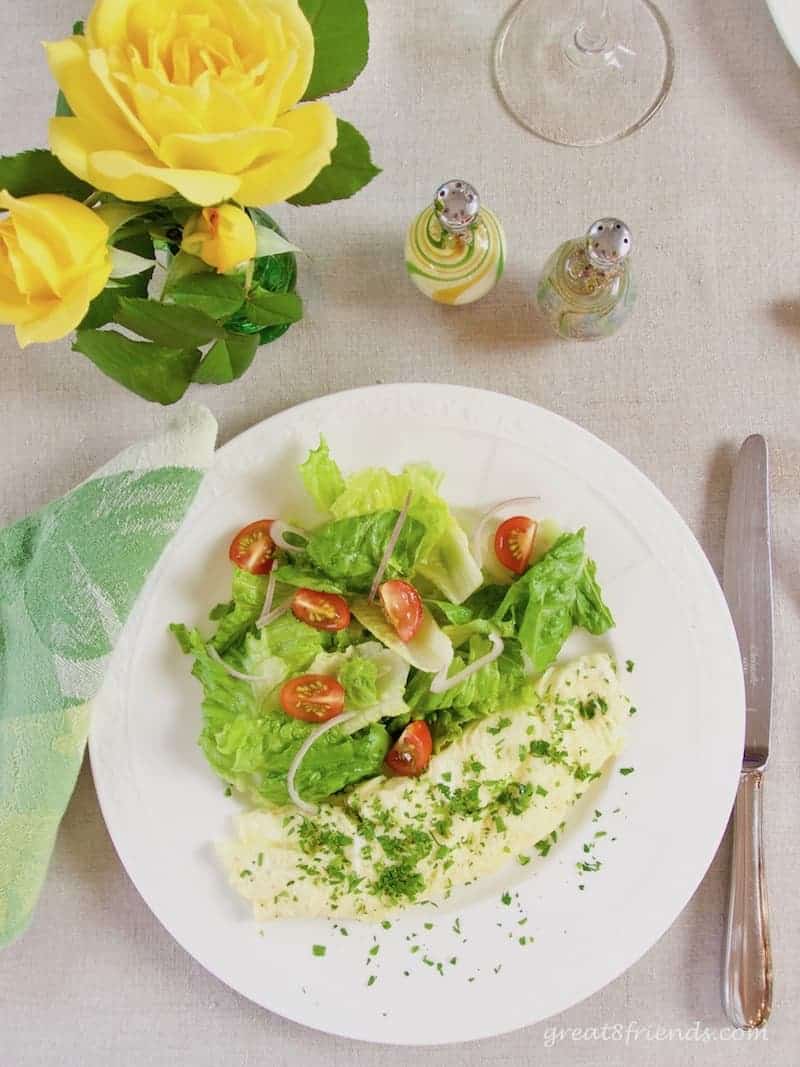 Overhead shot of a French omelette with a side salad.