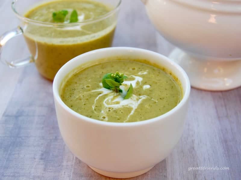 Two tea cups filled with spring pea soup.