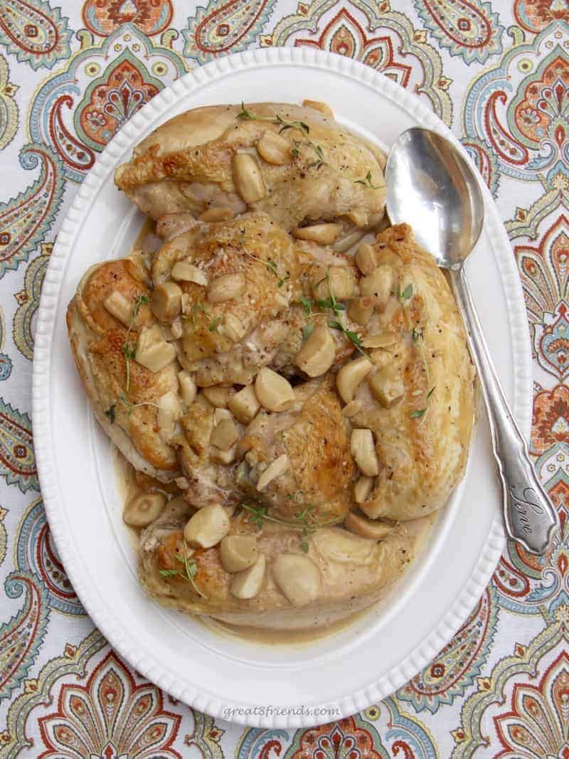 Platter of chicken with whole garlic cloves.