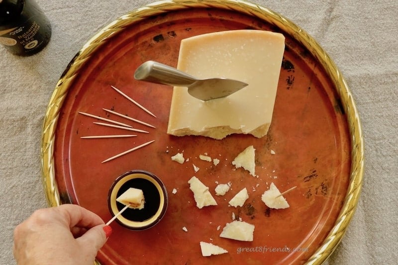 Overhead shot of Balsamic Vinegar with Cheese appetizer on copper tray.