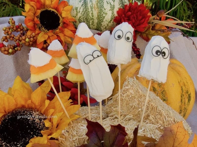 Fruit dressed in costume and ready for your All Hallow's Eve celebrations. These Halloween Candy Covered Fruit Treats are the perfect dessert!