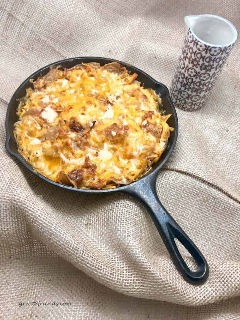 Cast iron skillet with cheesy nachos.