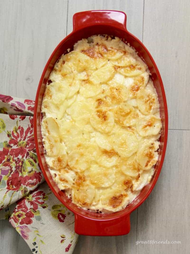 This Idaho Potato Gratin is flavorful, cheesy and a perfect side dish for meat, chicken or fish. The perfect make-ahead of time recipe!