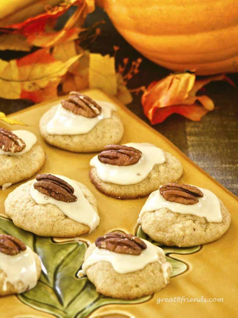 Pumpkin Cookies with Pecan halves on top.