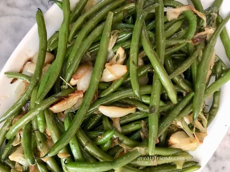 Overhead close up of green beans and onions.