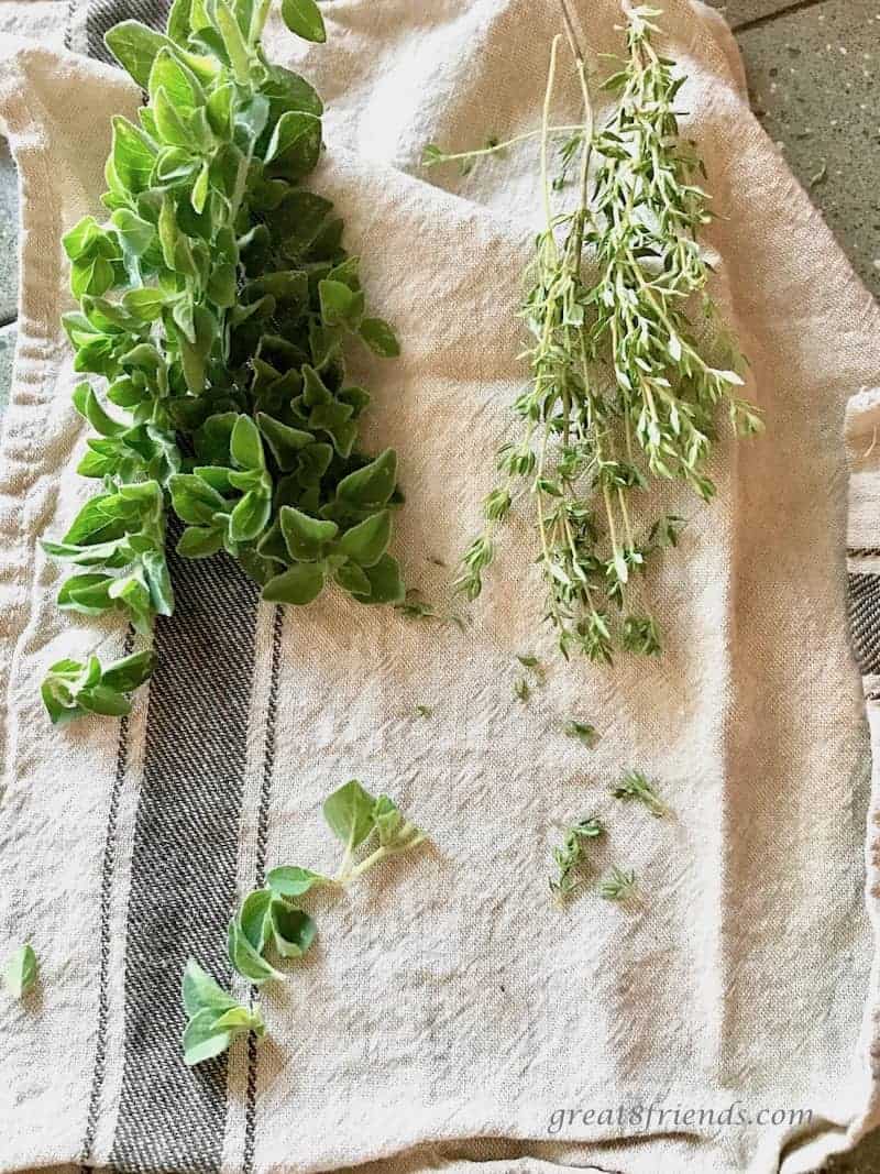 Fresh herbs on a kitchen towel.