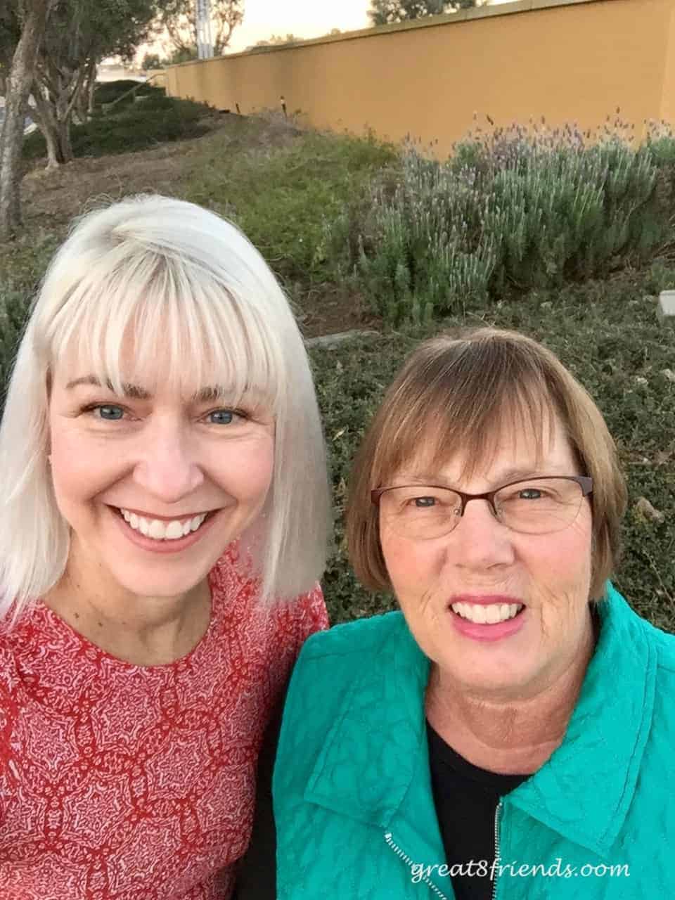 Two ladies smiling for the camera.