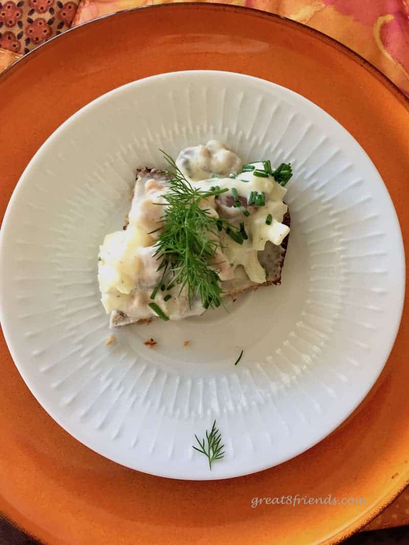 Overhead shot of one pickled herring salad open faced sandwich.