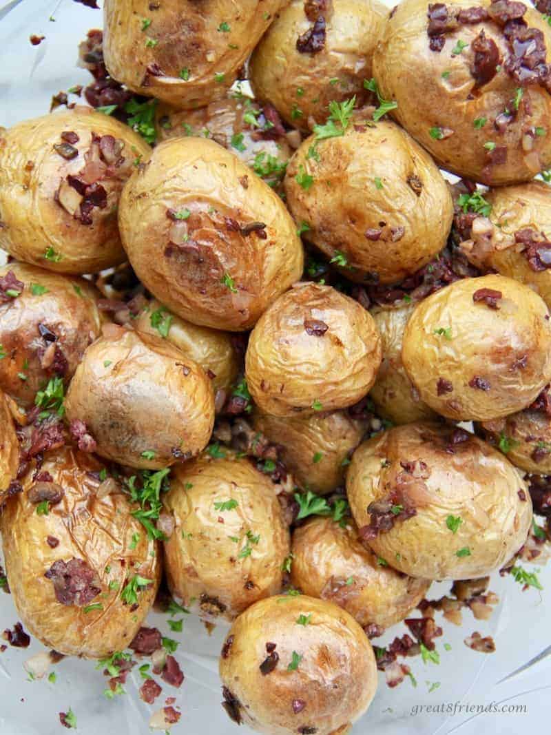 Upclose photo of dirty potatoes which are potatoes with an olive tapenade.