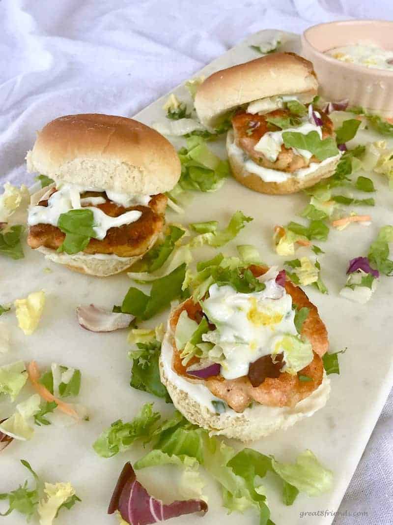 Three Salmon Sliders with a Tangy Lemony Yogurt Sauce.