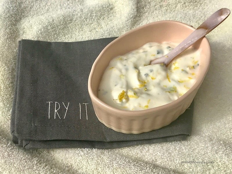 Tangy Lemony Yogurt Sauce in a small bowl with a small serving spoon.