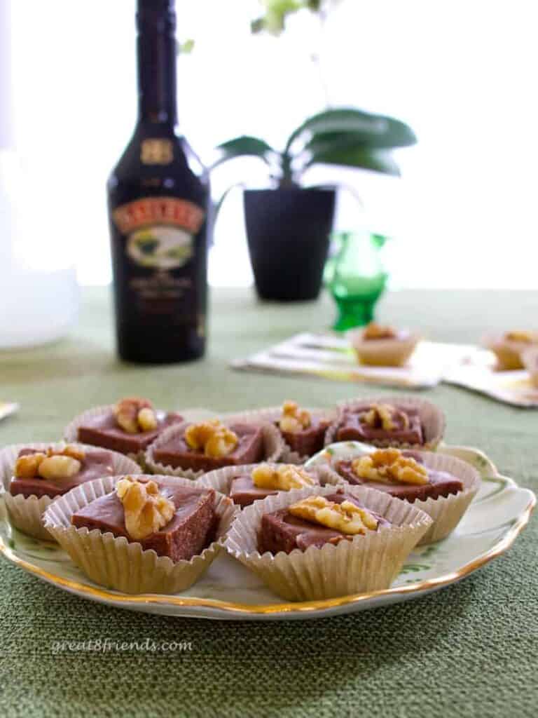 Plate of Irish Cream Fudge with a bottle of Baileys in the background.