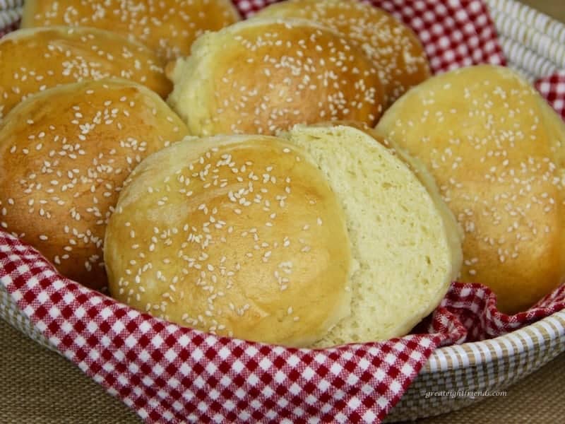 Basket with a red and white napkin holding Homemade Hamburger Buns.