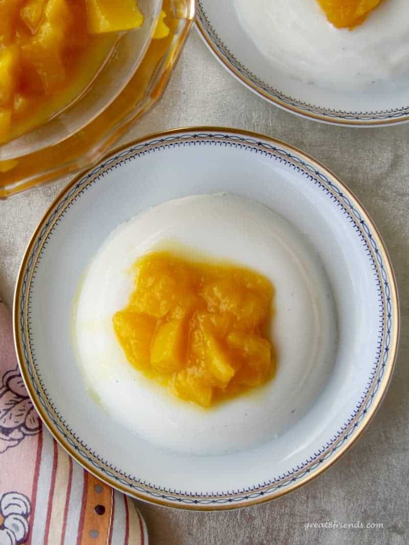 Impress your guests with this Vanilla Panna Cotta with Mango Compote. It is an unbelievably easy dessert to prepare, tasting much like a vanilla pudding with a bit of fresh fruit sweetness on top.