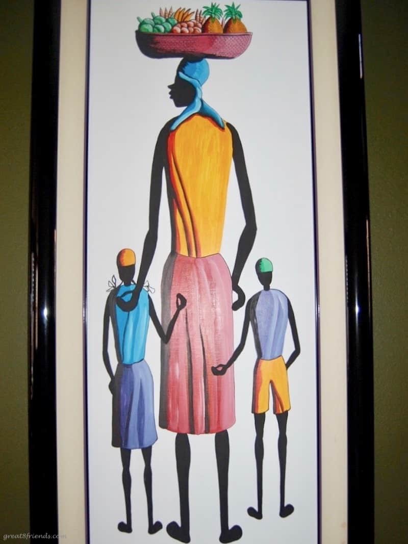 Colorful vertical painting of the back of a mom with a child on each side.