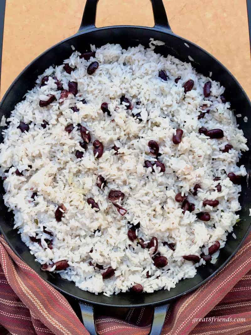Overhead shot of a black skillet with white rice and red beans.