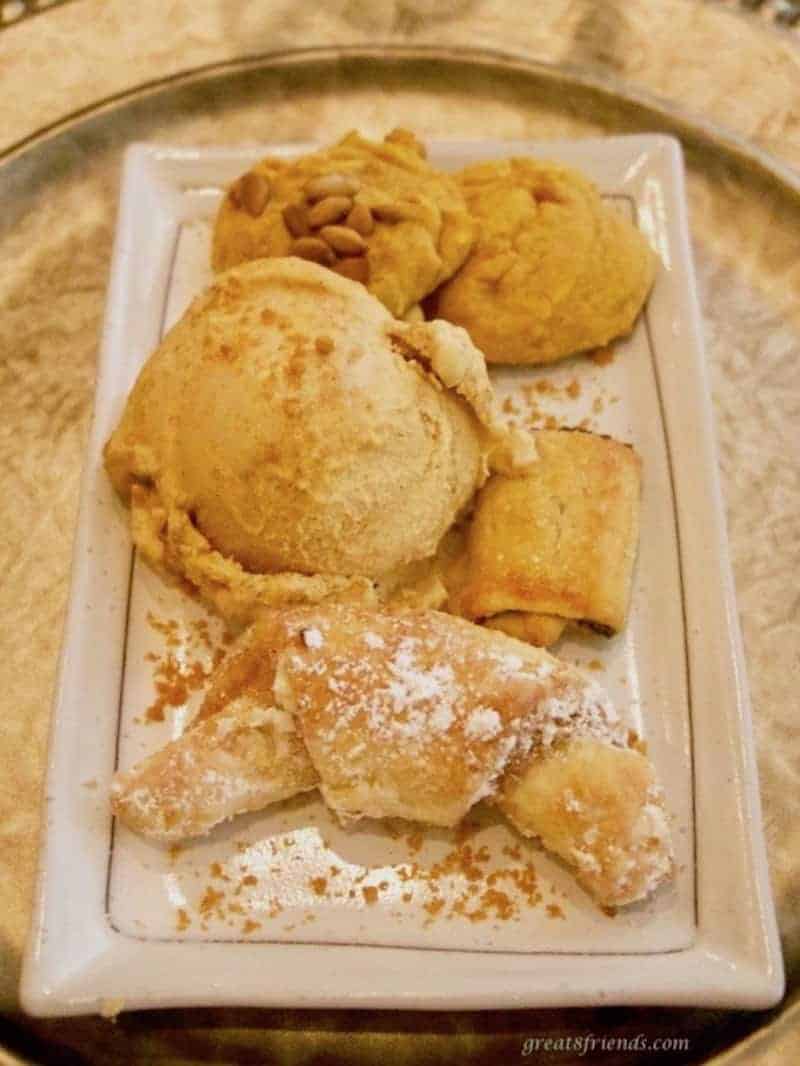 Pecan walnut crescent cookies served with pumpkin ice cream.