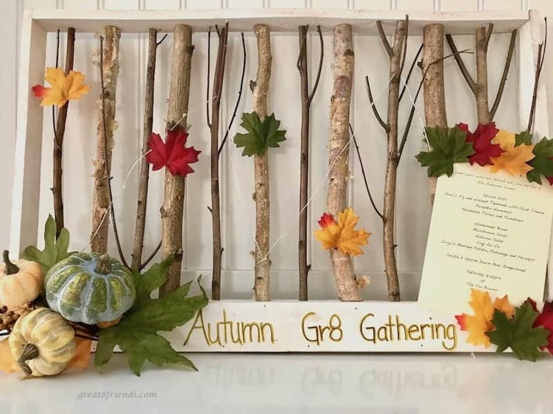 Great Eight Celebrates Autumn Invitation displayed with framed twigs and autumn leaves.