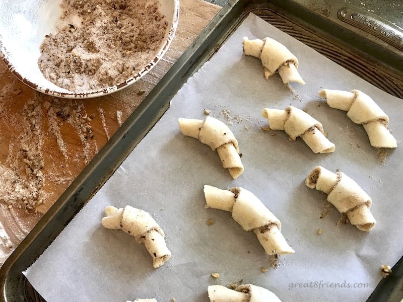 Cookie sheet with crescent cookies ready for the oven.