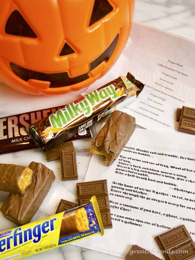 Halloween Haunt invitations, a plastic pumpkin, candy bars and the invitations.