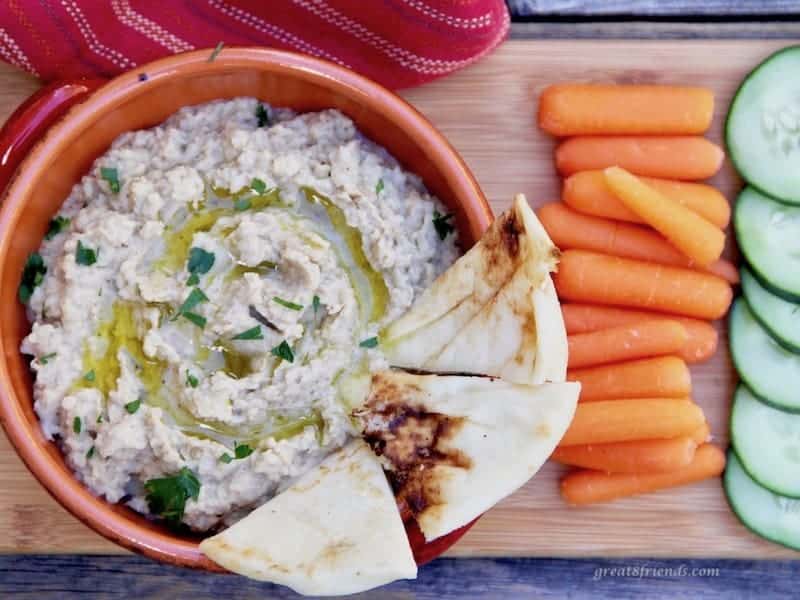 Baba Ganoush served with fresh vegetables and pita bread.