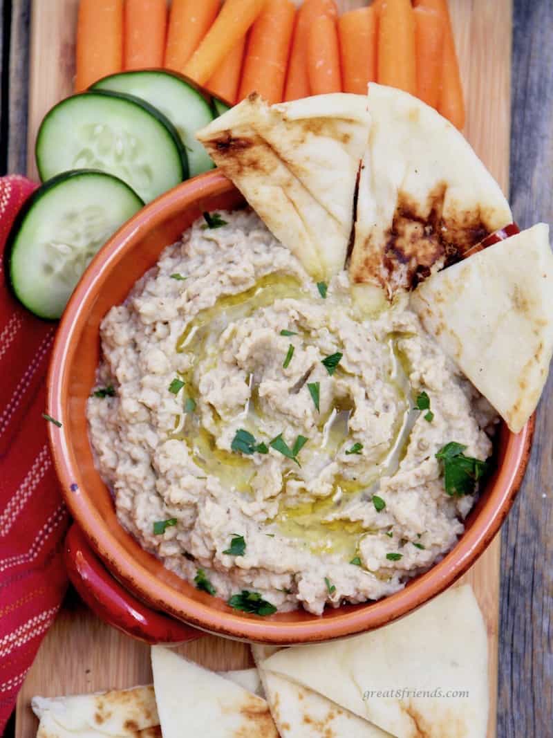 Baba Ganoush served with fresh vegetables and pita bread.