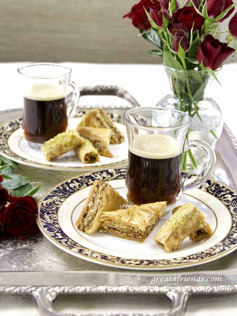 Two plates of Lebanese Baklava on silver tray with coffee