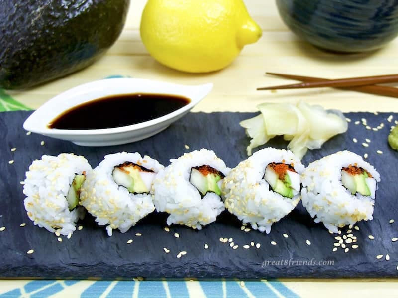 California Roll sliced with condiments and chopsticks