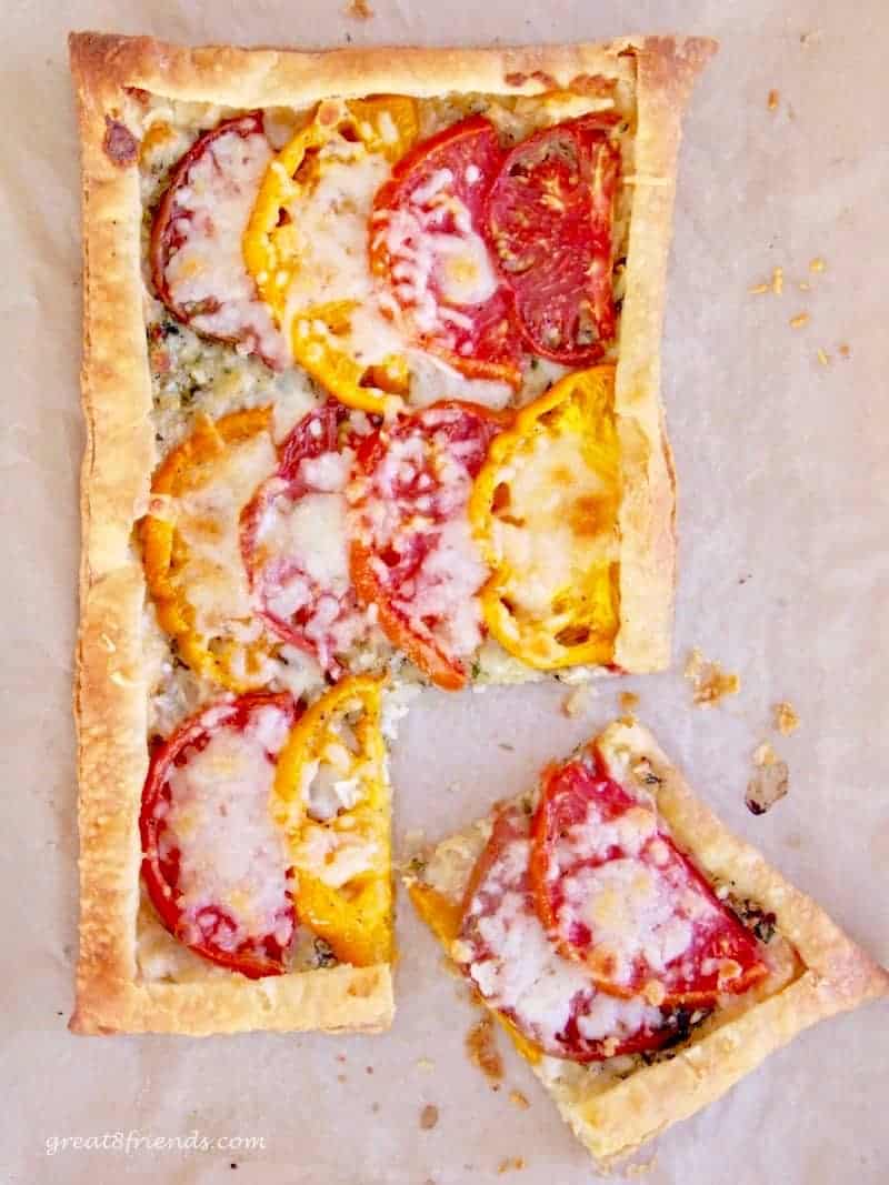 Baked Tomato Tart with sliced red and yellow tomatoes on puff pastry.