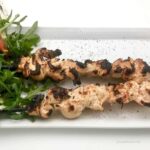 Middle Eastern Lemon Yogurt Chicken skewers served with arugula salad.