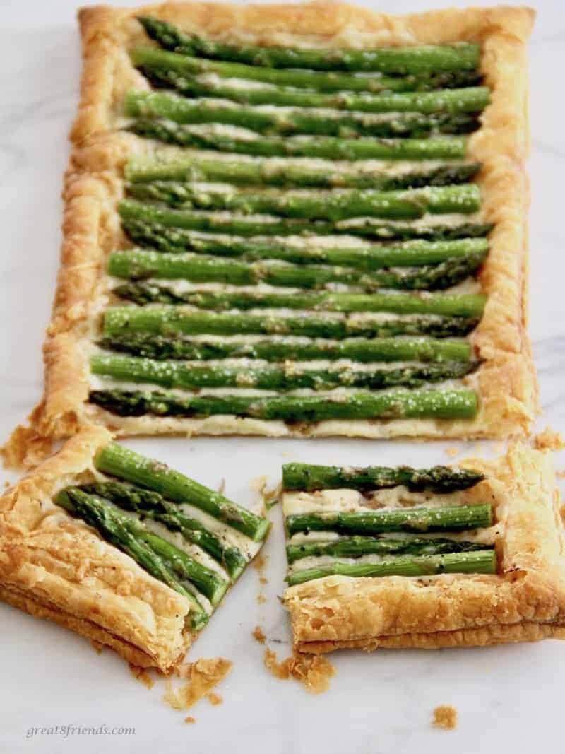 Asparagus Gruyere Tart with two cut pieces.