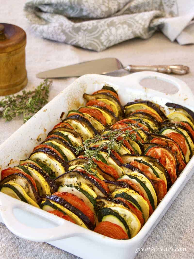 Provençal Vegetable Tian vertical photo in white casserole with silver server