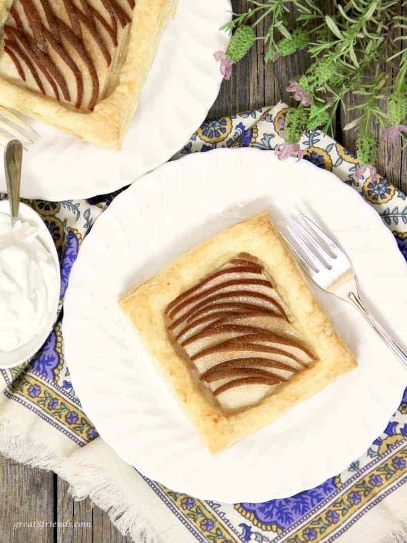Individual puff pastry pear tarts served with whipped cream