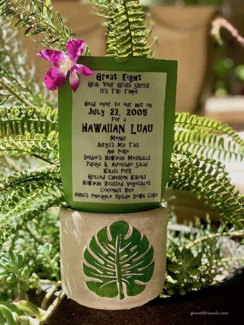 Hawaiian Luau dinner party invite on paper included with a fern in a ceramic vase with a fern leaf on it.