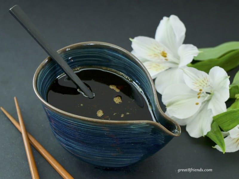 Teriyaki Sauce in blue ceramic dish with spoon 