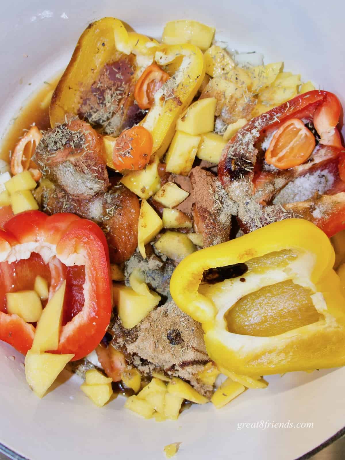 Pot of cut up vegetables and fruits with spices.