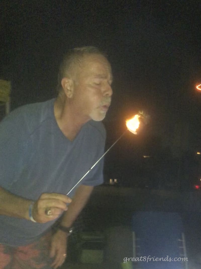 Joel blowing out the fire on a roasted marshmallow.