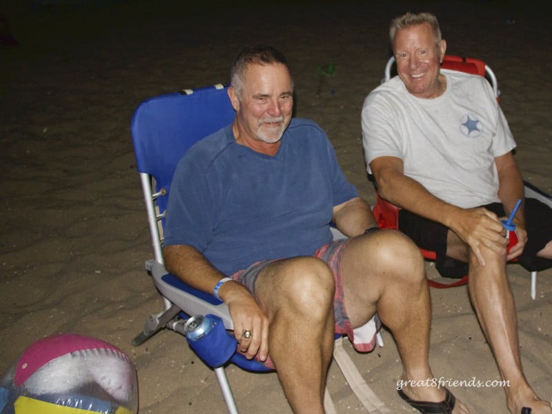 Joel and Tim sitting in beach chairs on the sand.