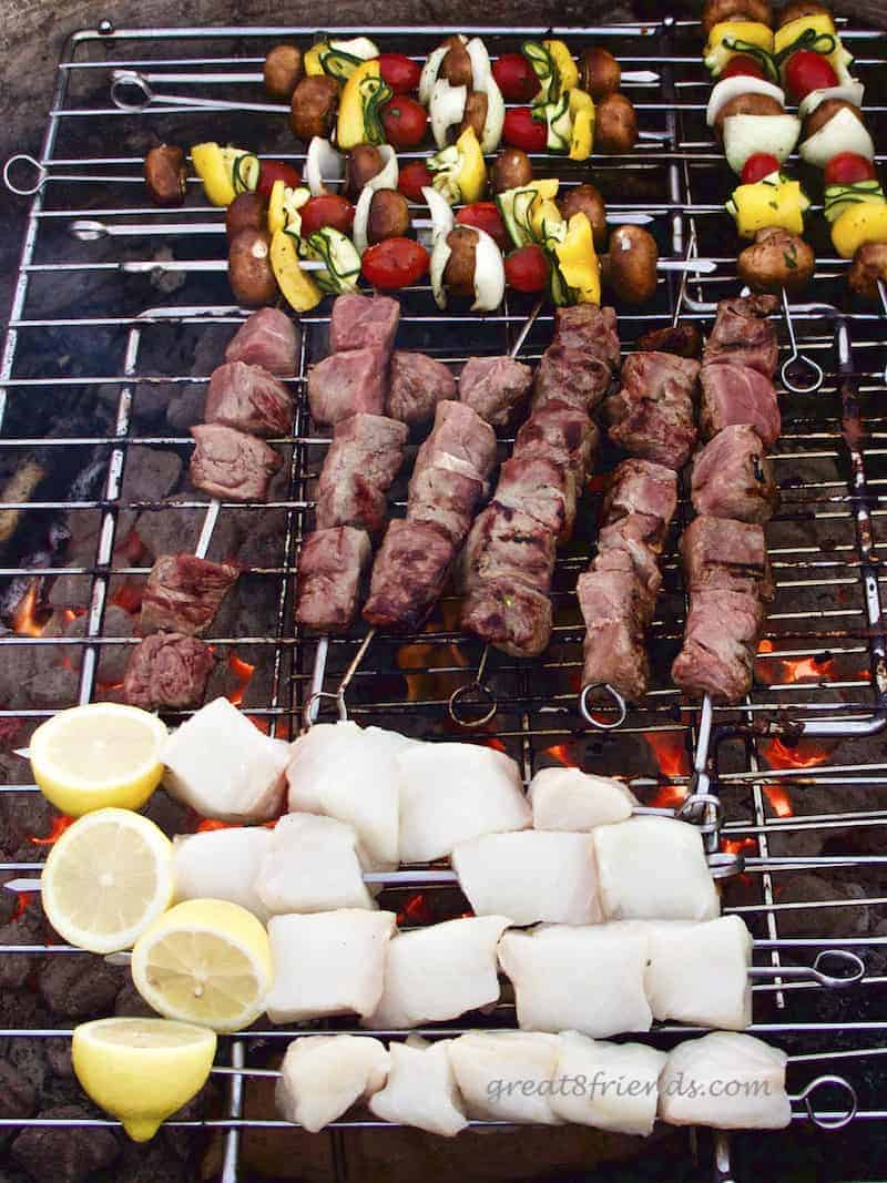 The grill at the beach barbecue with the veggie, beef and fish skewers.