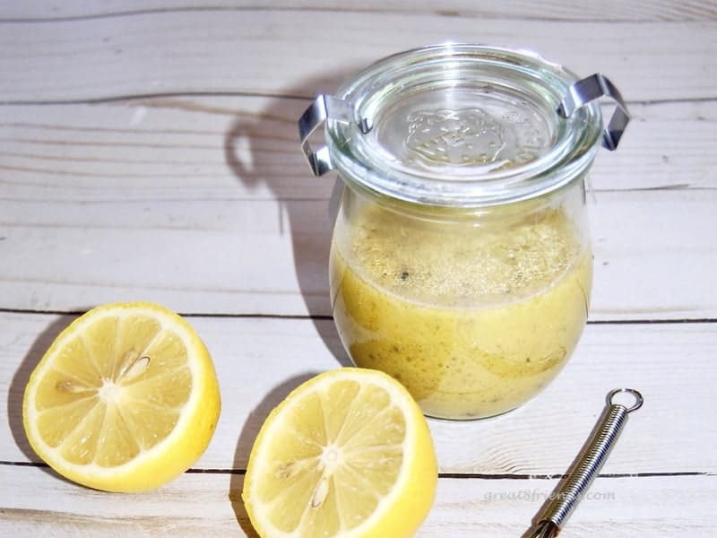 Lemon Dijon Vinaigrette in jar with lemon cut in half