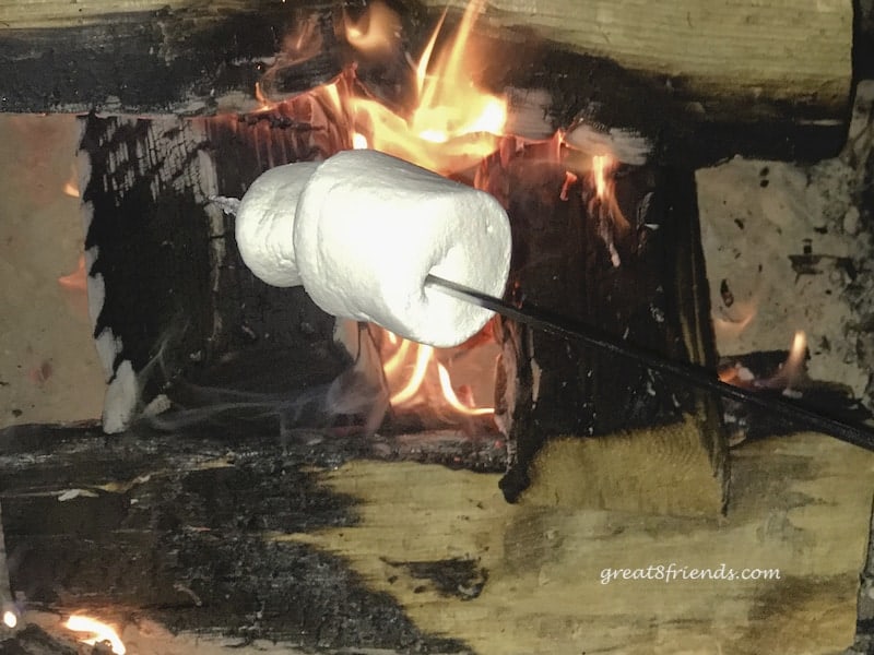 A marshmallow roasting over and open fire.