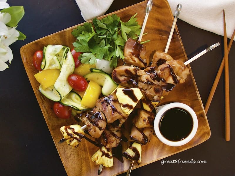 Teriyaki Chicken Skewers overhead shot on wooden plate with grilled veggies